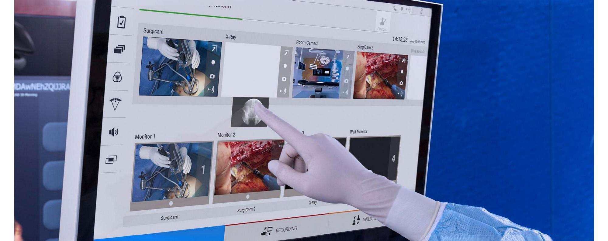 Gloved clinician uses the Helion system’s drag-and-drop functionality