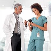 Nurse and clinician looking at a smartphone