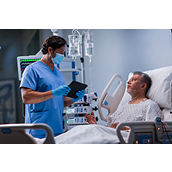 Clinician speaks with patient holding tablet